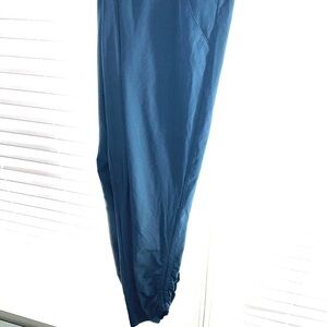 Dark blue joggers with adjustable sides on the leg